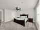 Carpeted bedroom features neutral walls, ceiling fan, and updated decor at 9189 Royal River Cir, Parrish, FL 34219