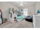 Charming bedroom features a bunk bed, ceiling fan, carpeted floors, and natural light at 9189 Royal River Cir, Parrish, FL 34219