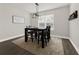 Dining room with black dining set, rug, wood floors, and a window with natural light at 9189 Royal River Cir, Parrish, FL 34219