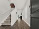 Hallway featuring hardwood floors and a staircase leading to the upper level of the home at 9189 Royal River Cir, Parrish, FL 34219