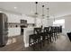 Spacious kitchen with white cabinets, stainless steel appliances, breakfast bar, and pendant lighting at 9189 Royal River Cir, Parrish, FL 34219