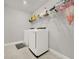Laundry room with modern white appliances and shelving at 9189 Royal River Cir, Parrish, FL 34219