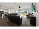 Open-concept living room with a ceiling fan, hardwood floors, and sliding glass doors to the backyard at 9189 Royal River Cir, Parrish, FL 34219
