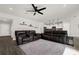 Living room featuring hardwood floors, a ceiling fan, and open access to the kitchen area at 9189 Royal River Cir, Parrish, FL 34219