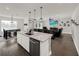Open living room flows from kitchen, featuring a dining area and access to the backyard through sliding glass doors at 9189 Royal River Cir, Parrish, FL 34219