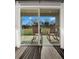 Relax on this screened patio with wood rocking chairs and a tranquil yard view at 9189 Royal River Cir, Parrish, FL 34219
