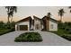 Modern home exterior with two-car garage and landscaping at 9468 Attica Cir, Port Charlotte, FL 33981