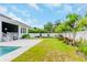 Landscaped backyard with pool and privacy fence at 111 S Cooper Pl, Tampa, FL 33609