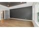 Bedroom with dark accent wall and hardwood floors at 111 S Cooper Pl, Tampa, FL 33609