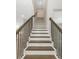 Modern staircase with dark wood railings and white risers at 111 S Cooper Pl, Tampa, FL 33609