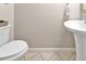 Small bathroom with pedestal sink and toilet at 2607 W Cleveland St # B, Tampa, FL 33609