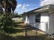 Side yard with grass and partial fencing at 402 Lomond Dr, Port Charlotte, FL 33953