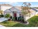 One-story house with a landscaped yard and driveway at 30350 Grymes Dr, Wesley Chapel, FL 33545