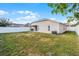Large grassy backyard with a white vinyl fence at 30350 Grymes Dr, Wesley Chapel, FL 33545