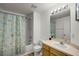 Bathroom with shower/tub combo, vanity, and patterned curtain at 30350 Grymes Dr, Wesley Chapel, FL 33545