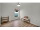 Small bedroom with wood floors and a bench at 30350 Grymes Dr, Wesley Chapel, FL 33545