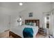 Bright bedroom with a wooden bed frame and teal blanket at 30350 Grymes Dr, Wesley Chapel, FL 33545