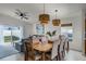 Dining room with a wooden table, six chairs, and light fixtures at 30350 Grymes Dr, Wesley Chapel, FL 33545