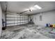Garage with an open garage door and concrete floor at 30350 Grymes Dr, Wesley Chapel, FL 33545