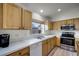 Kitchen features light wood cabinets, stainless steel appliances, and white countertops at 30350 Grymes Dr, Wesley Chapel, FL 33545