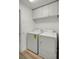Laundry room with washer, dryer, and overhead cabinets at 30350 Grymes Dr, Wesley Chapel, FL 33545
