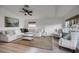 Spacious living room with light beige sectional sofa and light wood floors at 30350 Grymes Dr, Wesley Chapel, FL 33545