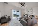 Living room with gray sectional sofa and access to backyard at 30350 Grymes Dr, Wesley Chapel, FL 33545