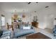 Open living space with gray sectional, dining area, and kitchen views at 30350 Grymes Dr, Wesley Chapel, FL 33545