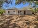 Newly constructed light beige home with a covered entryway and a spacious yard at 5220 Lords Ave, Sarasota, FL 34231
