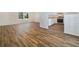 Modern kitchen with wood flooring, white cabinets, and stainless steel appliances at 5220 Lords Ave, Sarasota, FL 34231