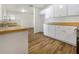 Modern kitchen with white cabinets and a butcher block countertop at 5220 Lords Ave, Sarasota, FL 34231