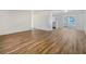 Open concept living and dining area with wood-look flooring at 5220 Lords Ave, Sarasota, FL 34231