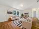 Bright living room featuring light beige walls, wood flooring, and comfy sofas at 5220 Lords Ave, Sarasota, FL 34231