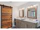Bathroom with double vanity and barn door at 8017 13Th S Ave, St Petersburg, FL 33707