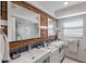 Spa-like bathroom with double vanity and wood feature wall at 8017 13Th S Ave, St Petersburg, FL 33707