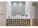 Soaking tub with designer tile surround in this bathroom at 8017 13Th S Ave, St Petersburg, FL 33707
