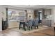 Bright dining room with modern table and chairs, wood floors and built in bar at 8017 13Th S Ave, St Petersburg, FL 33707