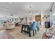 Open concept dining area with wooden table and blue chairs, offering view of living room at 8017 13Th S Ave, St Petersburg, FL 33707