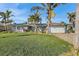 Single-story home with gray exterior, solar panels, and lush landscaping at 8017 13Th S Ave, St Petersburg, FL 33707