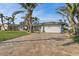 Single-story home with gray exterior, solar panels, and paver driveway at 8017 13Th S Ave, St Petersburg, FL 33707