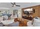 Living room features a large TV, comfortable seating and hardwood floors at 8017 13Th S Ave, St Petersburg, FL 33707