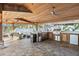 Covered outdoor kitchen with seating area at 8017 13Th S Ave, St Petersburg, FL 33707