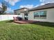 This home has a wooden deck and a spacious backyard with a privacy fence at 39567 Dawson Chase Dr, Zephyrhills, FL 33540