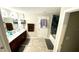 Spacious bathroom features double sink vanity, tile floors, and a separate room for the toilet and shower at 39567 Dawson Chase Dr, Zephyrhills, FL 33540