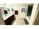 Bathroom featuring double sink vanity, tile floors, and a separate room for the toilet and shower at 39567 Dawson Chase Dr, Zephyrhills, FL 33540