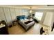 This bedroom features paneled walls and wood-look floors, providing a bright and modern aesthetic at 39567 Dawson Chase Dr, Zephyrhills, FL 33540