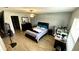 Spacious bedroom with ceiling fan, wood floors, and an accent wall adds a stylish touch at 39567 Dawson Chase Dr, Zephyrhills, FL 33540