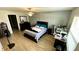 Spacious bedroom with ceiling fan, wood floors, and an accent wall adds a stylish touch at 39567 Dawson Chase Dr, Zephyrhills, FL 33540