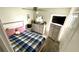 Bright bedroom featuring a ceiling fan, bed with plaid bedding, and modern dresser at 39567 Dawson Chase Dr, Zephyrhills, FL 33540