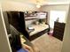A bedroom with bunkbeds, a ceiling fan, and carpeted floors at 39567 Dawson Chase Dr, Zephyrhills, FL 33540